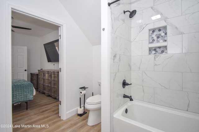 full bathroom with bathtub / shower combination, toilet, and wood finished floors