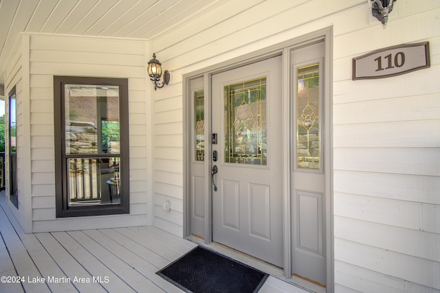 view of exterior entry with a porch