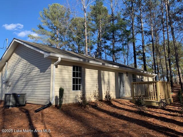 view of property exterior with central air condition unit and a deck