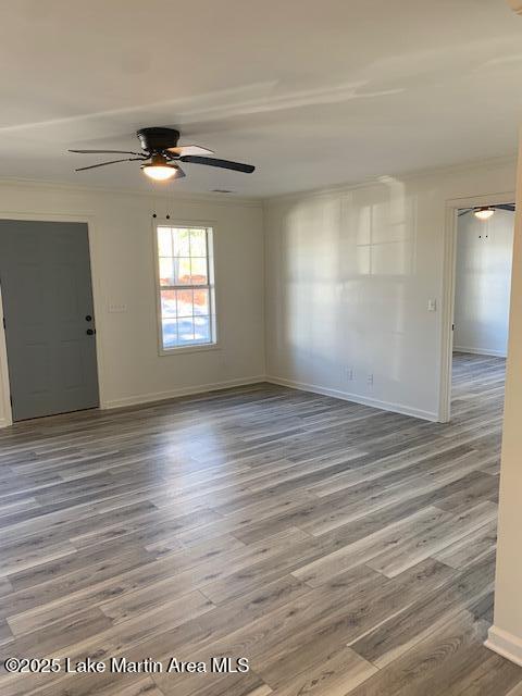 unfurnished room featuring ceiling fan and wood-type flooring