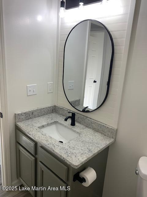 bathroom featuring toilet and vanity