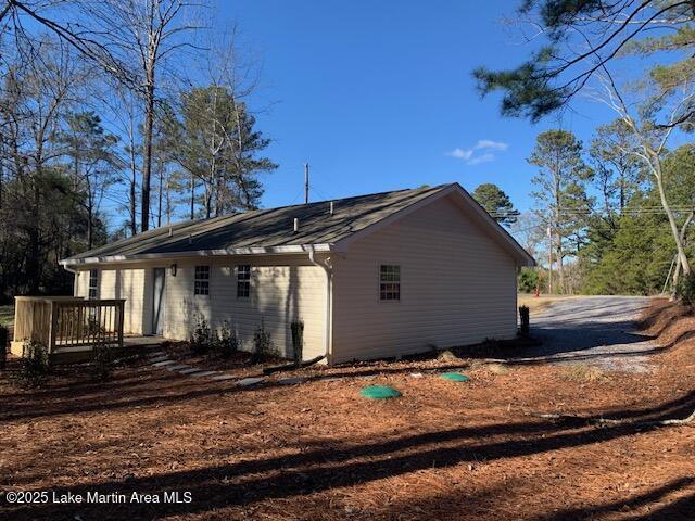 view of property exterior with a wooden deck