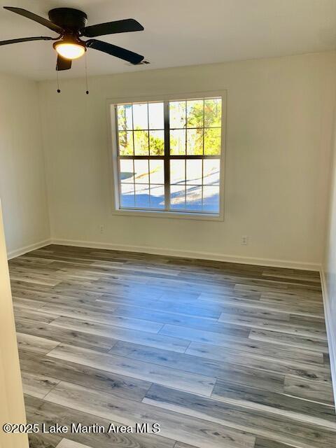 spare room with ceiling fan and hardwood / wood-style flooring