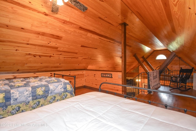 bedroom with hardwood / wood-style flooring, wood ceiling, wooden walls, and vaulted ceiling