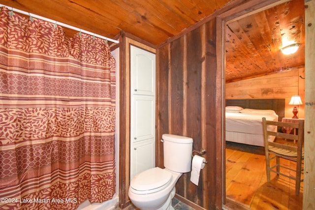 bathroom featuring wood walls, lofted ceiling, toilet, wood-type flooring, and wood ceiling