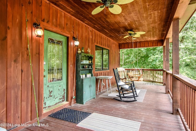 wooden deck featuring covered porch and ceiling fan