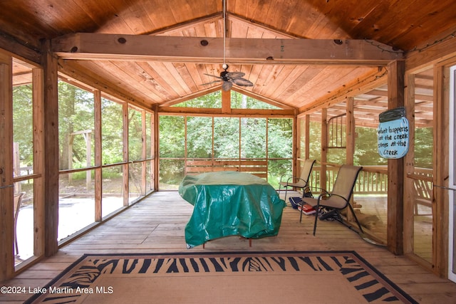 unfurnished sunroom with ceiling fan, wood ceiling, and a wealth of natural light