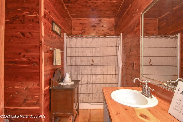 bathroom featuring wooden ceiling, vanity, hardwood / wood-style flooring, and wooden walls