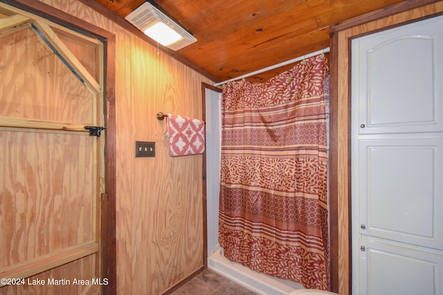 bathroom with wood ceiling and wood walls