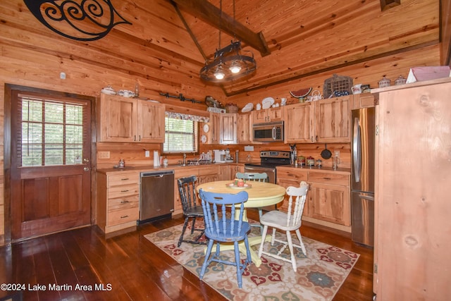 kitchen featuring dark hardwood / wood-style flooring, plenty of natural light, beamed ceiling, and appliances with stainless steel finishes