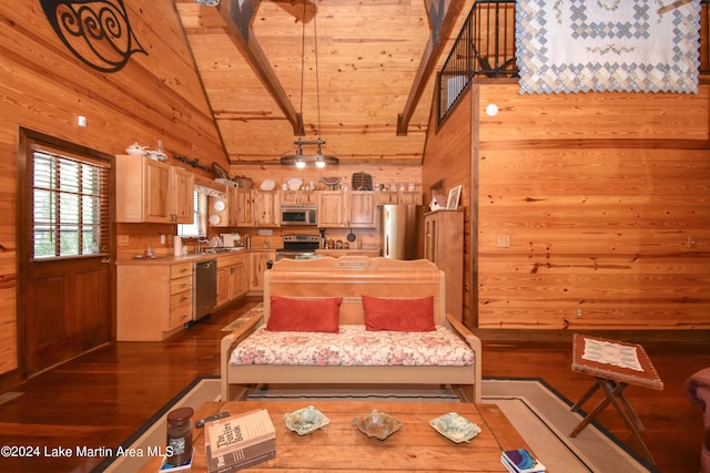 living room featuring wood walls, high vaulted ceiling, sink, beam ceiling, and wood-type flooring