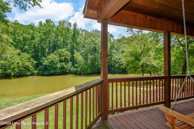 wooden deck with a water view and a yard