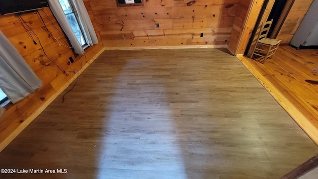 room details with wood-type flooring and wooden walls