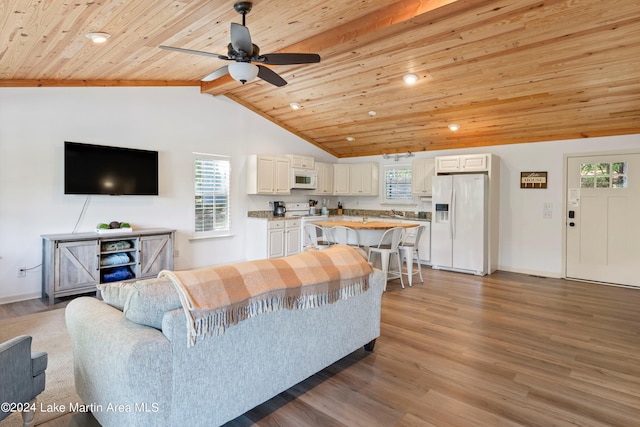 living room with lofted ceiling with beams, ceiling fan, wood-type flooring, and wooden ceiling