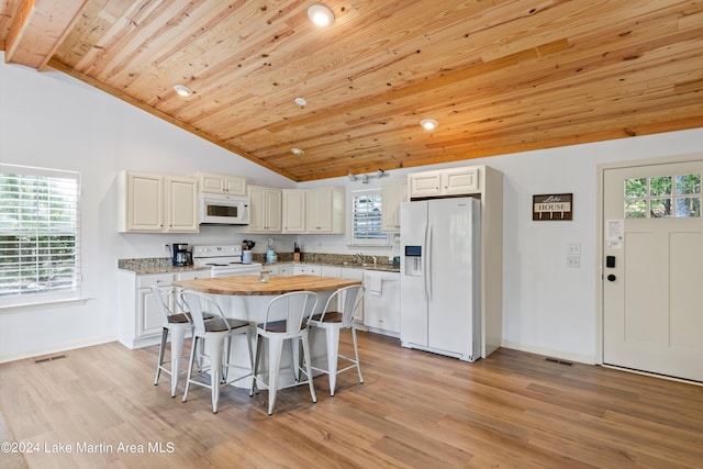 kitchen featuring a healthy amount of sunlight, wooden ceiling, white appliances, and light wood-type flooring