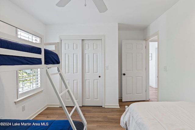 bedroom featuring hardwood / wood-style flooring, ceiling fan, and a closet