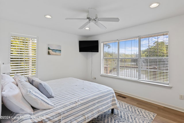 bedroom with ceiling fan and hardwood / wood-style floors