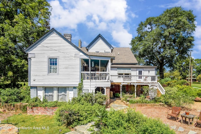 back of property with a wooden deck