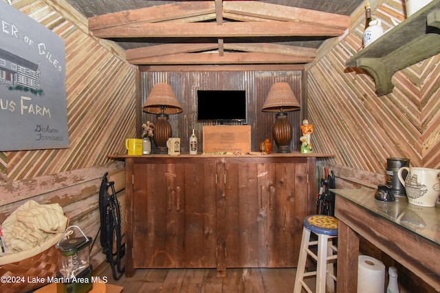 bar featuring wood walls and hardwood / wood-style floors