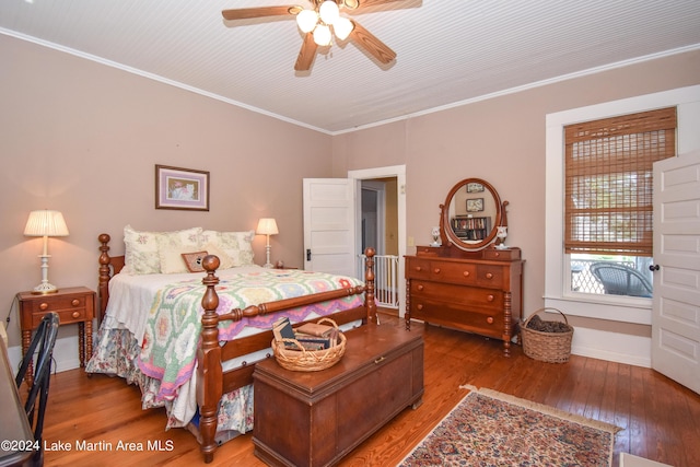 bedroom featuring ceiling fan, wood-type flooring, and crown molding