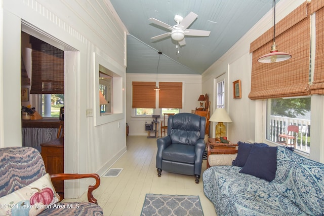 living room featuring ceiling fan, vaulted ceiling, and hardwood / wood-style flooring