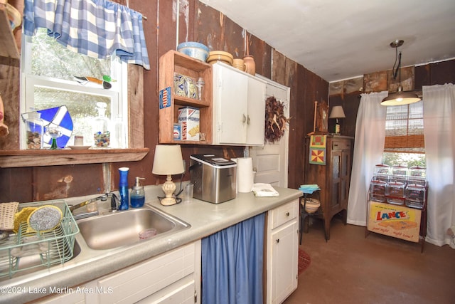 kitchen featuring white cabinets and hanging light fixtures