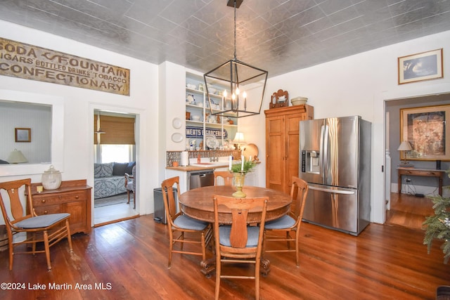 dining room featuring an inviting chandelier and dark wood-type flooring