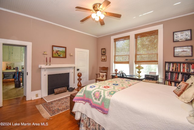 bedroom featuring ceiling fan, dark hardwood / wood-style flooring, and crown molding