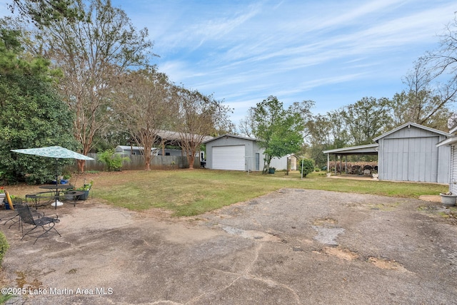 view of yard featuring a garage and an outdoor structure