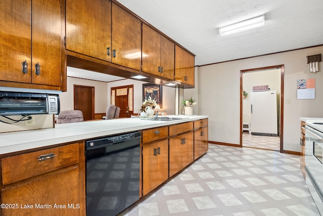 kitchen featuring crown molding, sink, white appliances, and a textured ceiling