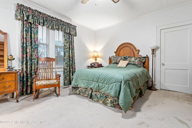 bedroom featuring ornamental molding, carpet, and ceiling fan