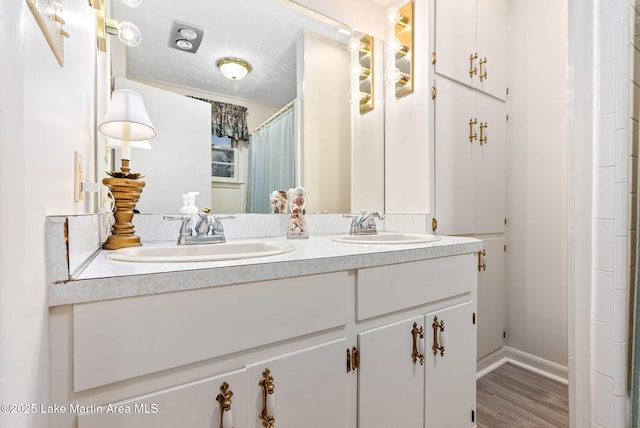 bathroom with vanity, hardwood / wood-style floors, a textured ceiling, and a shower with shower curtain