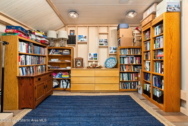 3408 Quail Cv, Opelika, AL 36801 - sitting room with wall of books, wooden ceiling, and lofted ceiling