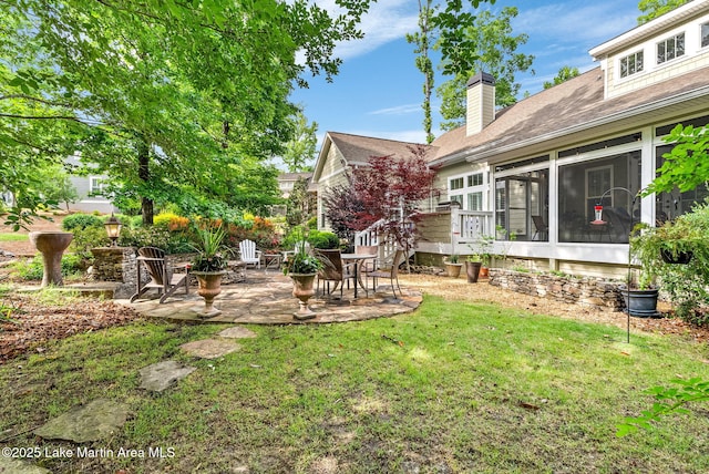 3408 Quail Cv, Opelika, AL 36801 - view of grassy yard with a patio and a sunroom