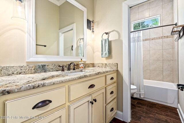 3408 Quail Cv, Opelika, AL 36801 - full bathroom with toilet, vanity, wood finished floors, and shower / tub combo