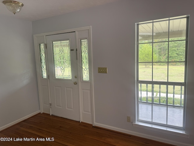 foyer entrance featuring wood finished floors and baseboards