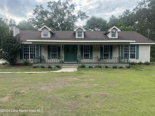 cape cod home with covered porch and a front lawn