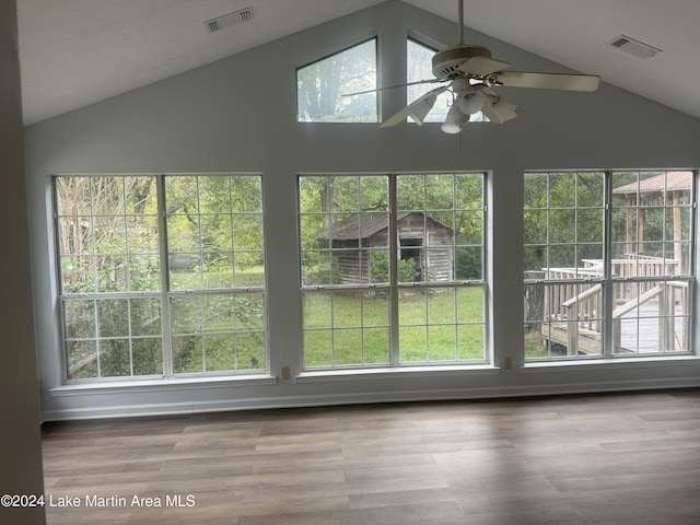 unfurnished sunroom with plenty of natural light, visible vents, and vaulted ceiling