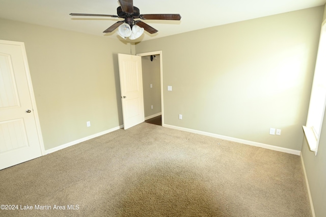 spare room with ceiling fan and carpet floors