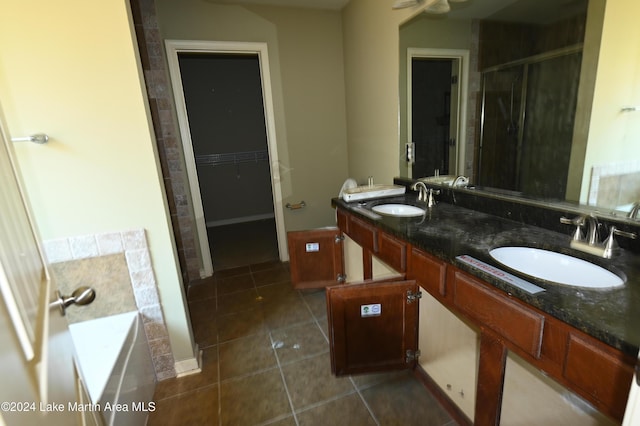 bathroom with tile patterned flooring, vanity, and independent shower and bath