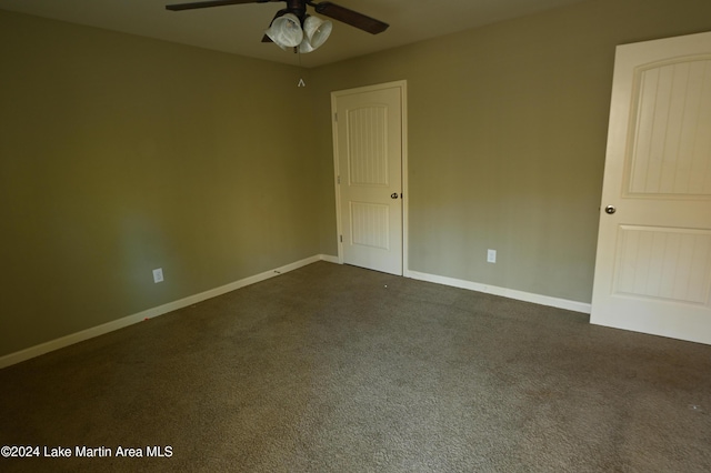 carpeted spare room with ceiling fan