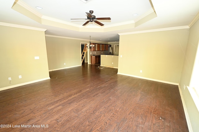 unfurnished room with a tray ceiling, dark hardwood / wood-style flooring, ceiling fan, and crown molding