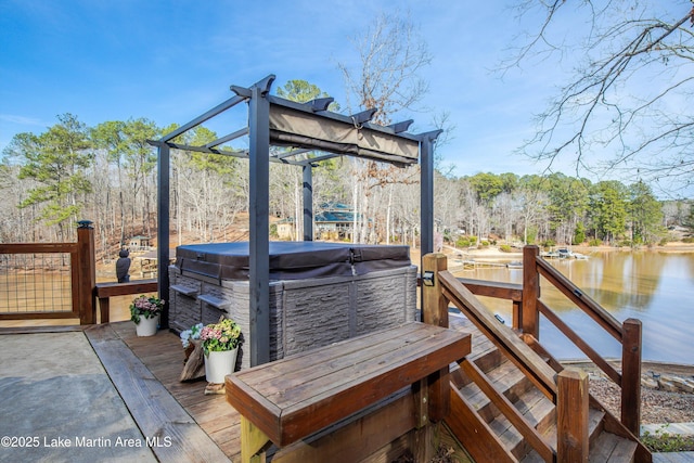 wooden terrace with a water view, a hot tub, and a pergola