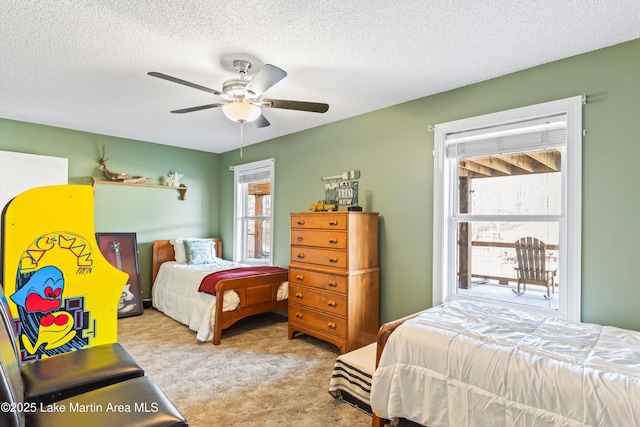 carpeted bedroom with a textured ceiling and ceiling fan