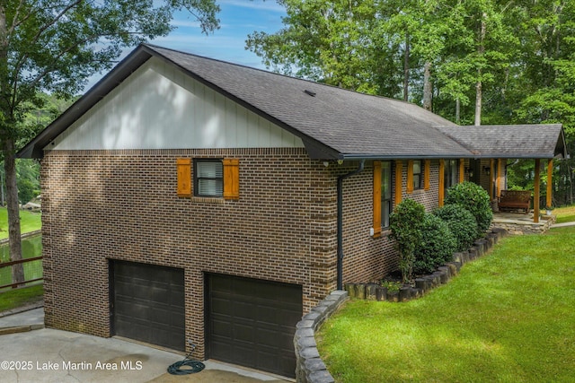 57 Lakeview Pt, Alexander City, AL 35010 - view of home's exterior with roof with shingles, brick siding, a lawn, an attached garage, and driveway
