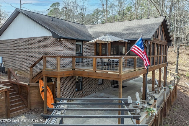 57 Lakeview Pt, Alexander City, AL 35010 - rear view of property with a shingled roof, a deck, brick siding, and stairway