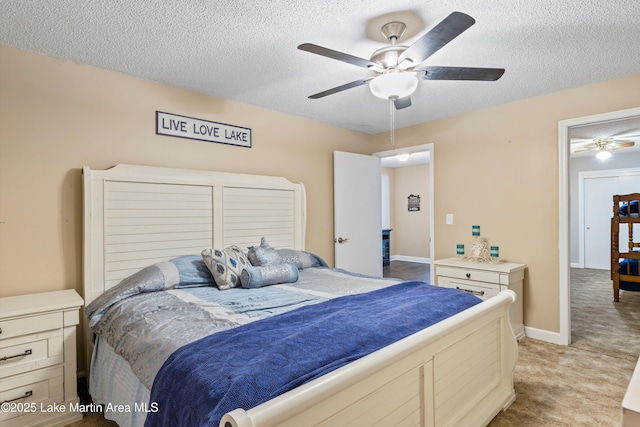 bedroom with a textured ceiling, a ceiling fan, and light carpet