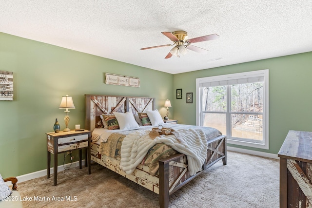 bedroom with a textured ceiling, baseboards, and carpet flooring