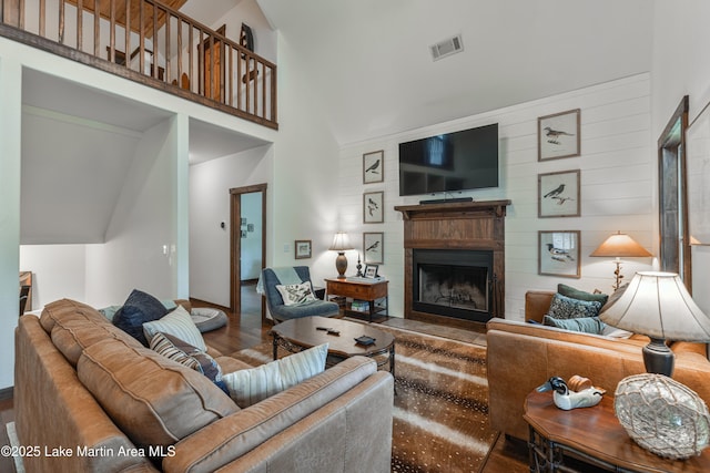 254 Paces Way, Dadeville, AL 36853 - living room with high vaulted ceiling, wood finished floors, a fireplace, baseboards, and wood walls