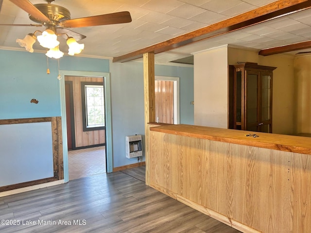 kitchen with heating unit, wood finished floors, beamed ceiling, and ceiling fan